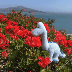 Image showing the Knitted Organic Cotton Blue Diplodocus Dinosaur Baby Rattle, Blue product.